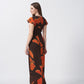 Back view of an ankle-length crepe dress with ruffle sleeves and a fluid silhouette