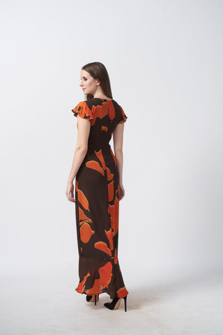 Back view of an ankle-length crepe dress with ruffle sleeves and a fluid silhouette