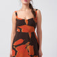 Abstract print crepe midi dress in orange and brown tones, suitable for daytime gatherings and casual outings