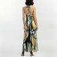 Back view of the Olive Dawn halter-neck maxi dress highlighting the open back with a slender crossover halter tie and a fluid straight-fit silhouette.