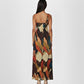 Sleeveless maxi dress with a continuous abstract mosaic print in shades of rust, ochre, and blue. 