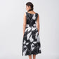 Back view of a sleeveless black and white abstract print midi dress in cotton satin