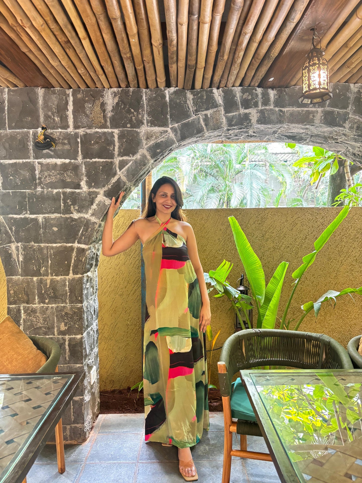 Long halter-neck dress featuring a vibrant, brushstroke abstract print in forest green and sage with bold magenta accents, ideal for tropical vacations or summer garden parties.