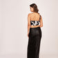Back profile of the one-shoulder abstract co-ord set showing the clean zip closure and snug fit of the skirt.