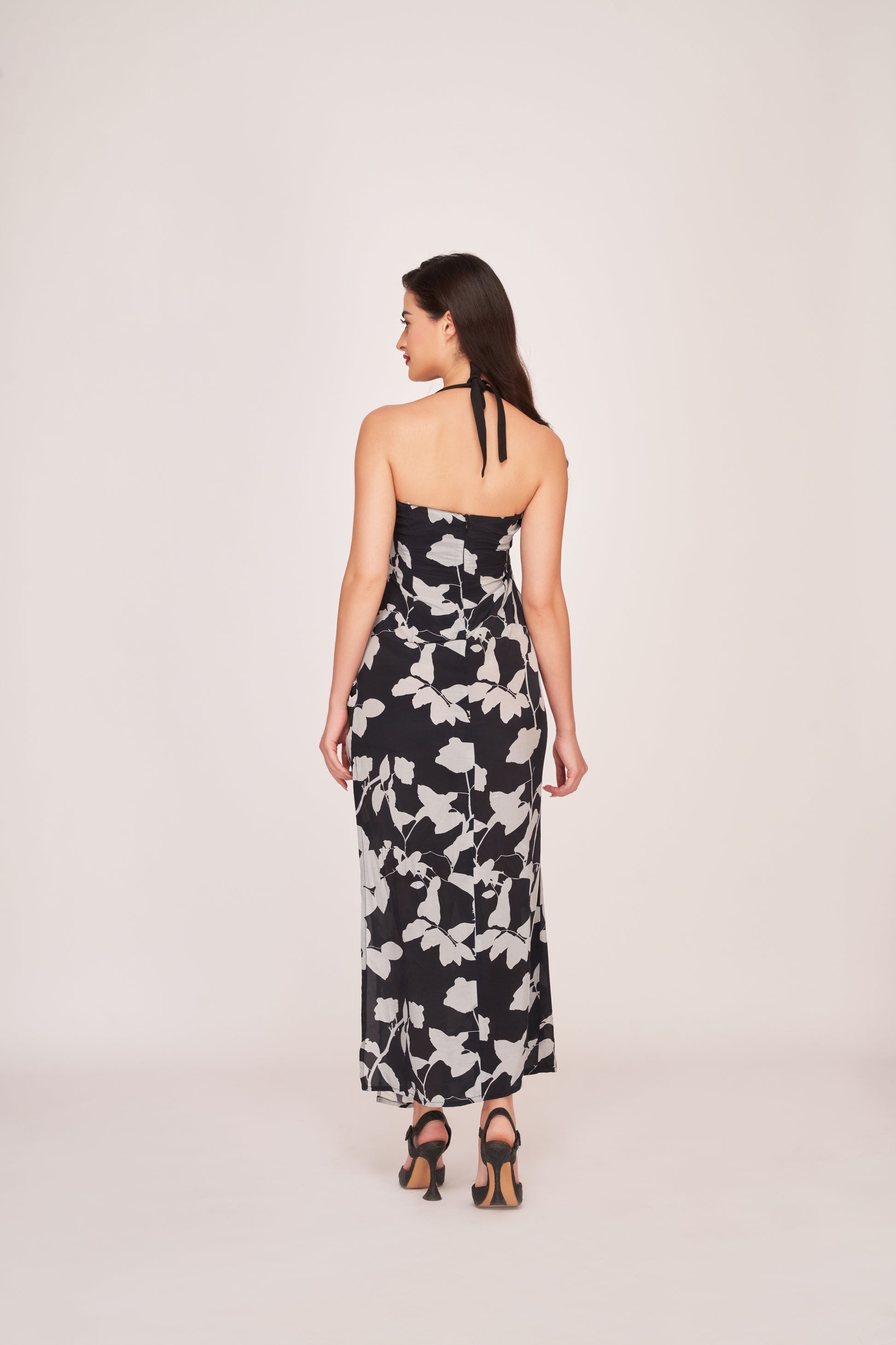 Rear view of the crepe ankle-length dress showing back zip closure and shoulder strap details.