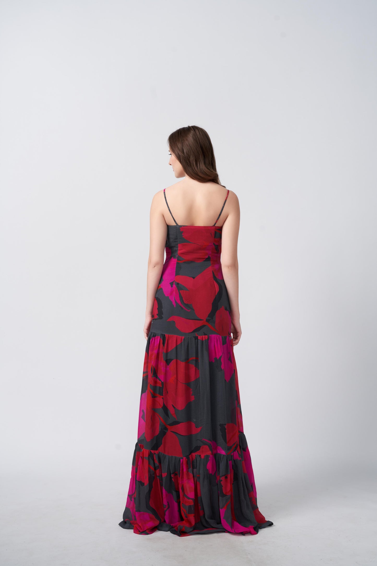 Back view of a full-length chinon dress with a flowing silhouette and shoulder straps
