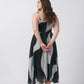 Close-up of delicate shoulder straps and neckline on a green abstract print crepe midi dress
