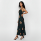 Deep green ankle-length crepe dress featuring wide shoulder straps, a notched square neckline, and earthy geometric motifs, ideal for sophisticated daytime occasions or refined evening wear.