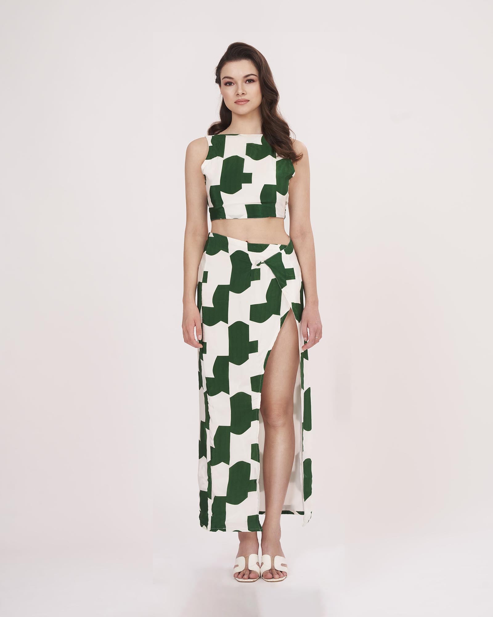 Model standing straight with arms by her side, offering a clear front view of the green abstract co-ord’s structure and fit.