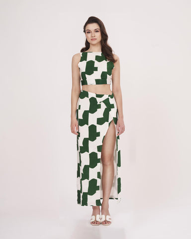 Model standing straight with arms by her side, offering a clear front view of the green abstract co-ord’s structure and fit.