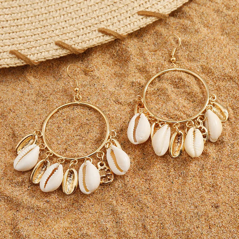 Imitation Gold Shell Drop Earrings featuring large circular hoops with multiple dangling white cowrie shells and gold charms