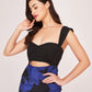 Side-angle close-up of model in sweetheart neck floral long dress, highlighting waist cut-out and neckline.
