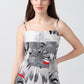 Close-up of model highlighting the square neckline and spaghetti strap details of the floral satin dress.