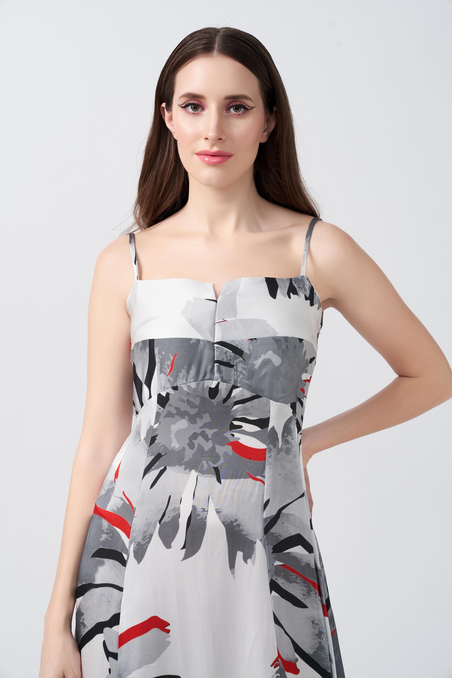 Close-up of model highlighting the square neckline and spaghetti strap details of the floral satin dress.