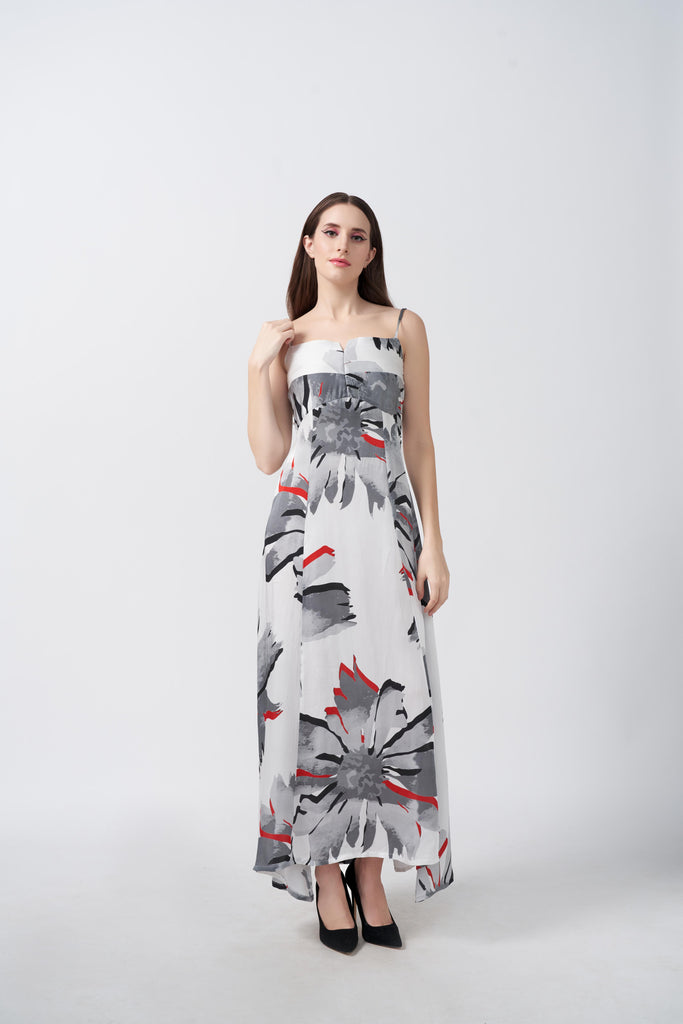 Model wearing ankle-length satin dress with white and grey floral print and spaghetti straps, standing front-facing.