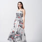 Model in a relaxed stance wearing grey floral ankle-length dress with a hint of red and a clean, modern finish