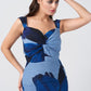 Close-up of the twisted neckline and shoulder straps in the blue floral print midi dress, focusing on the design details.