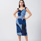 Model posing front-facing in a sleeveless midi dress with twisted neckline and blue floral print, showcasing the flattering fit.