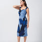 Full-body side profile of the model in light and dark blue floral midi dress, highlighting the dress’s flow and midi length.