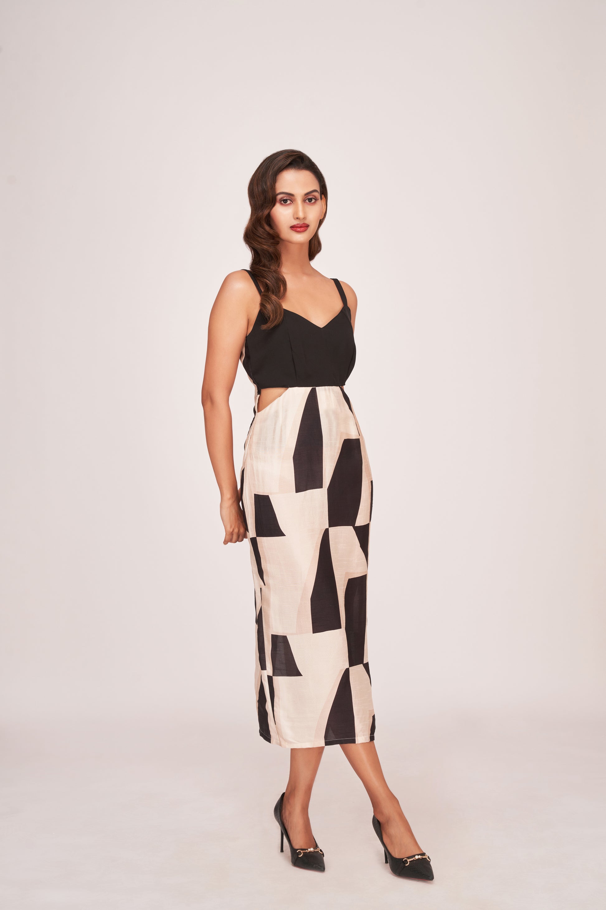 Full-length front view of the abstract printed satin midi dress with strap shoulders and chic side cut detailing.