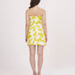 Back view of the model in yellow tube dress, focusing on the zip closure and clean finish.