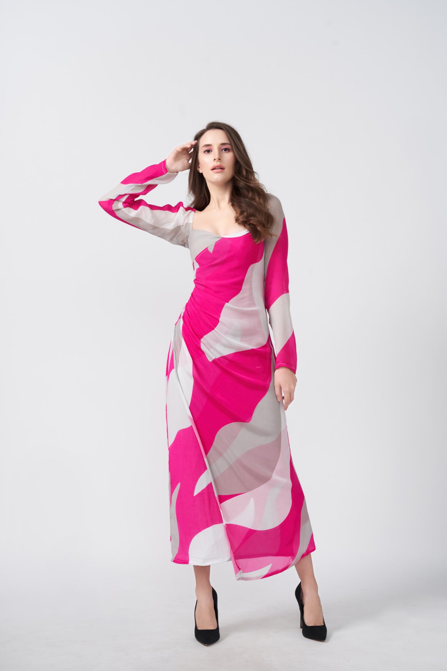 An ankle-length dress featuring a vibrant pink and grey abstract wave print, designed with long sheer sleeves and a flattering gathered waistline.