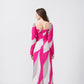 Backview of a woman modeling a pink and white abstract print ankle-length dress, 