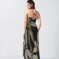 Model showing back view of navy and beige wrap dress featuring tie-back halter neck and side waist tie.