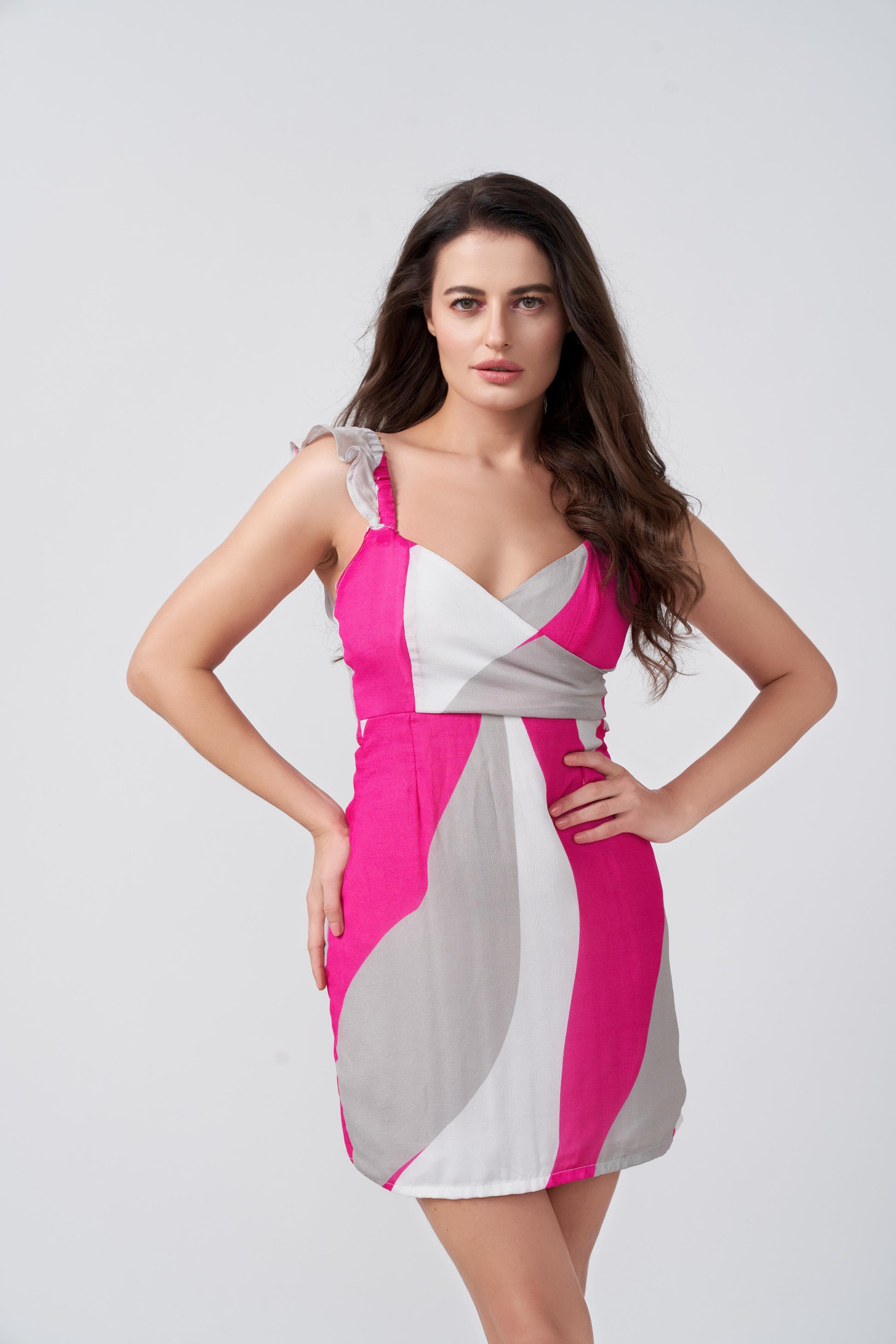 Close-up of model in short dress with wrap-stitched neckline and frill shoulder details.