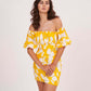 Close-up of model in yellow floral off-shoulder mini dress with puff sleeves, hands held gracefully in front.
