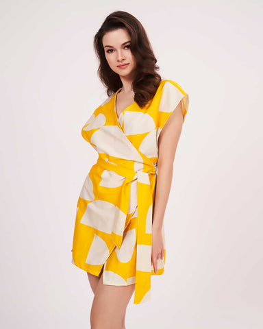 Sleeveless wrap-neck yellow cotton satin dress, ideal for warm-weather trips and casual brunches