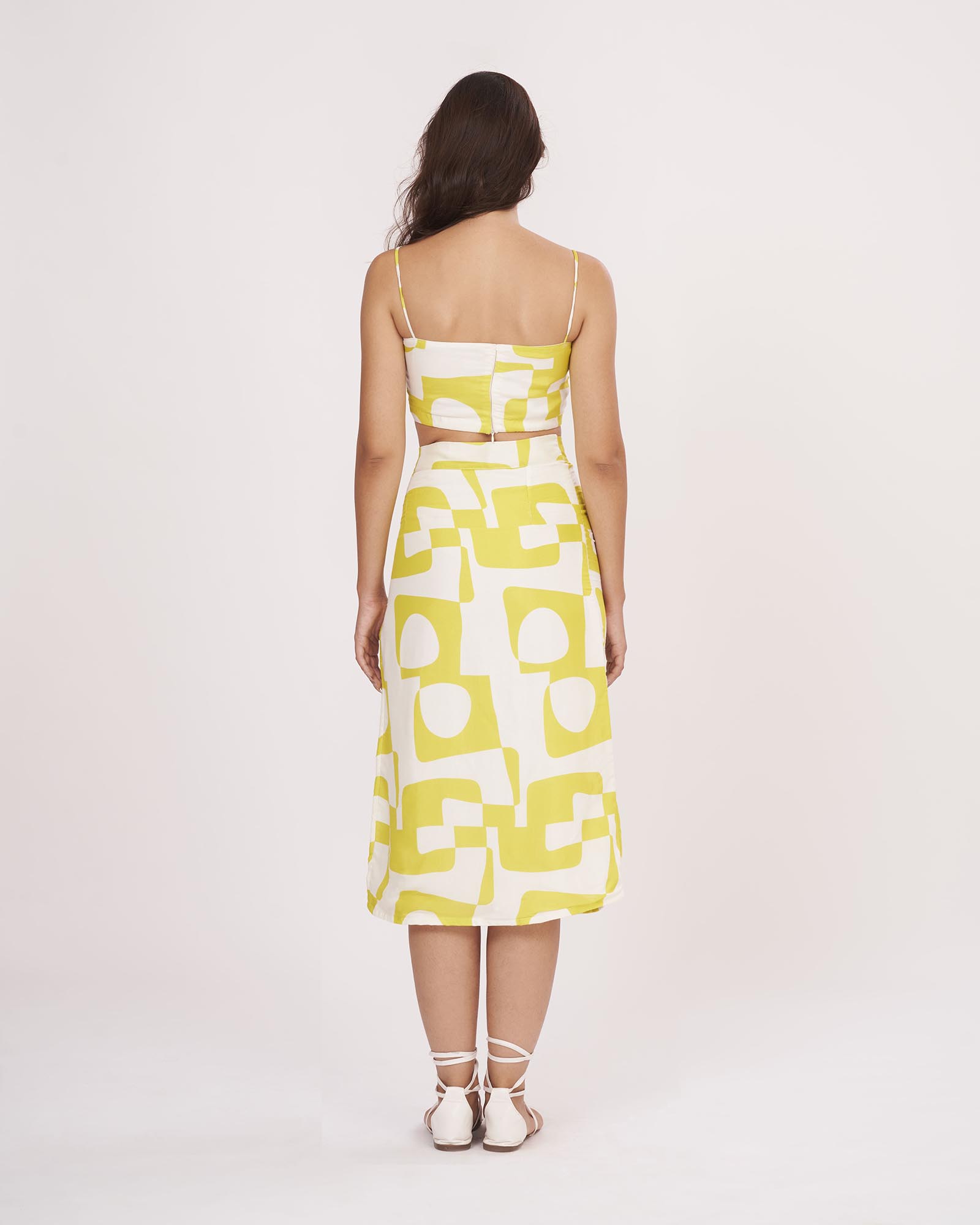 Rear view of the yellow co-ord set showing back zip closure and symmetrical strap detailing