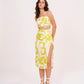 Model in standing pose wearing the yellow printed strappy co-ord set, highlighting the square neckline, fitted waist, and thigh-high slit.