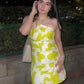 Close-up of model in yellow printed tube dress, highlighting the geometric print and fitted silhouette.