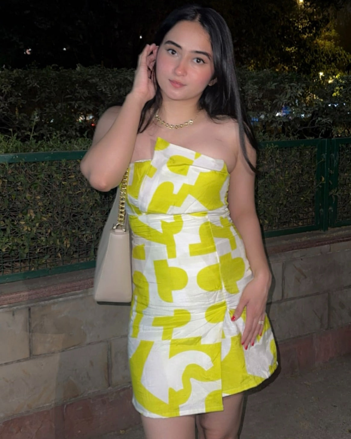 Close-up of model in yellow printed tube dress, highlighting the geometric print and fitted silhouette.