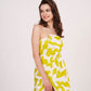 Studio pose with model slightly turned, showcasing the accented cut and front slit of the yellow dress.