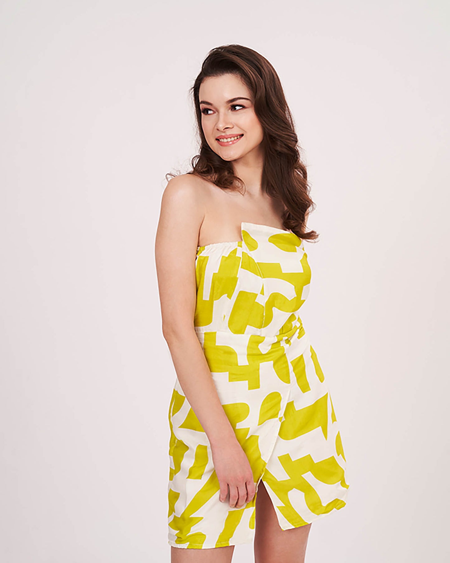 Studio pose with model slightly turned, showcasing the accented cut and front slit of the yellow dress.