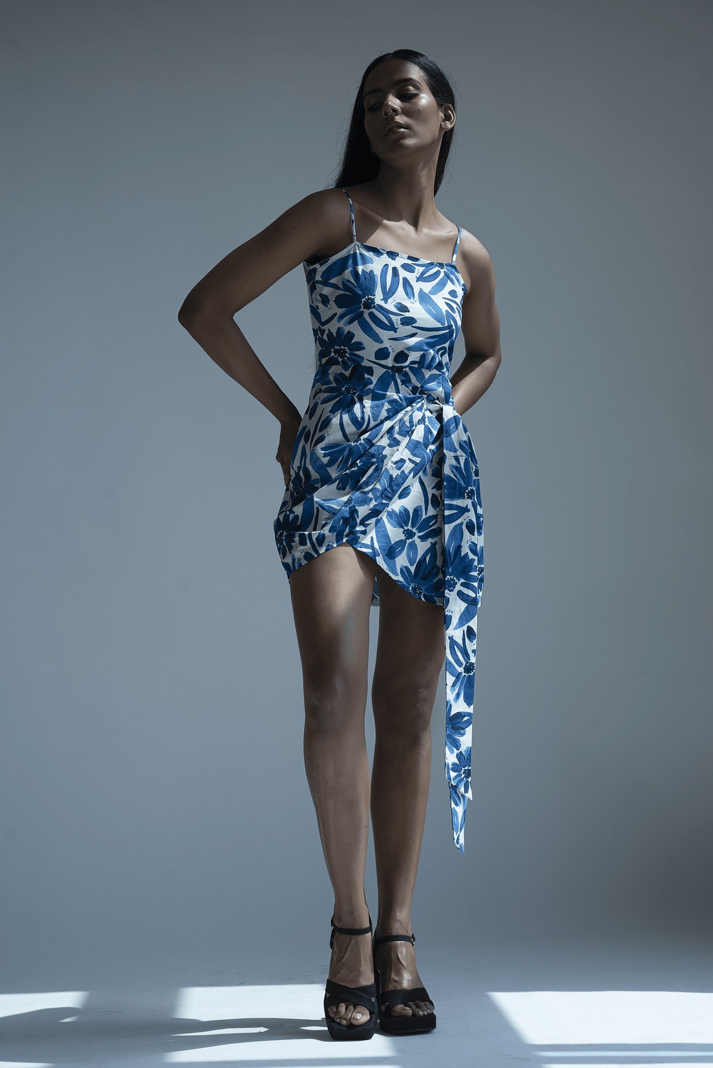 Abstract blue midi vacation dress made of breathable cotton fabric with wrap style tie-up detailing and a flattering midi length. Perfect for summer occasions