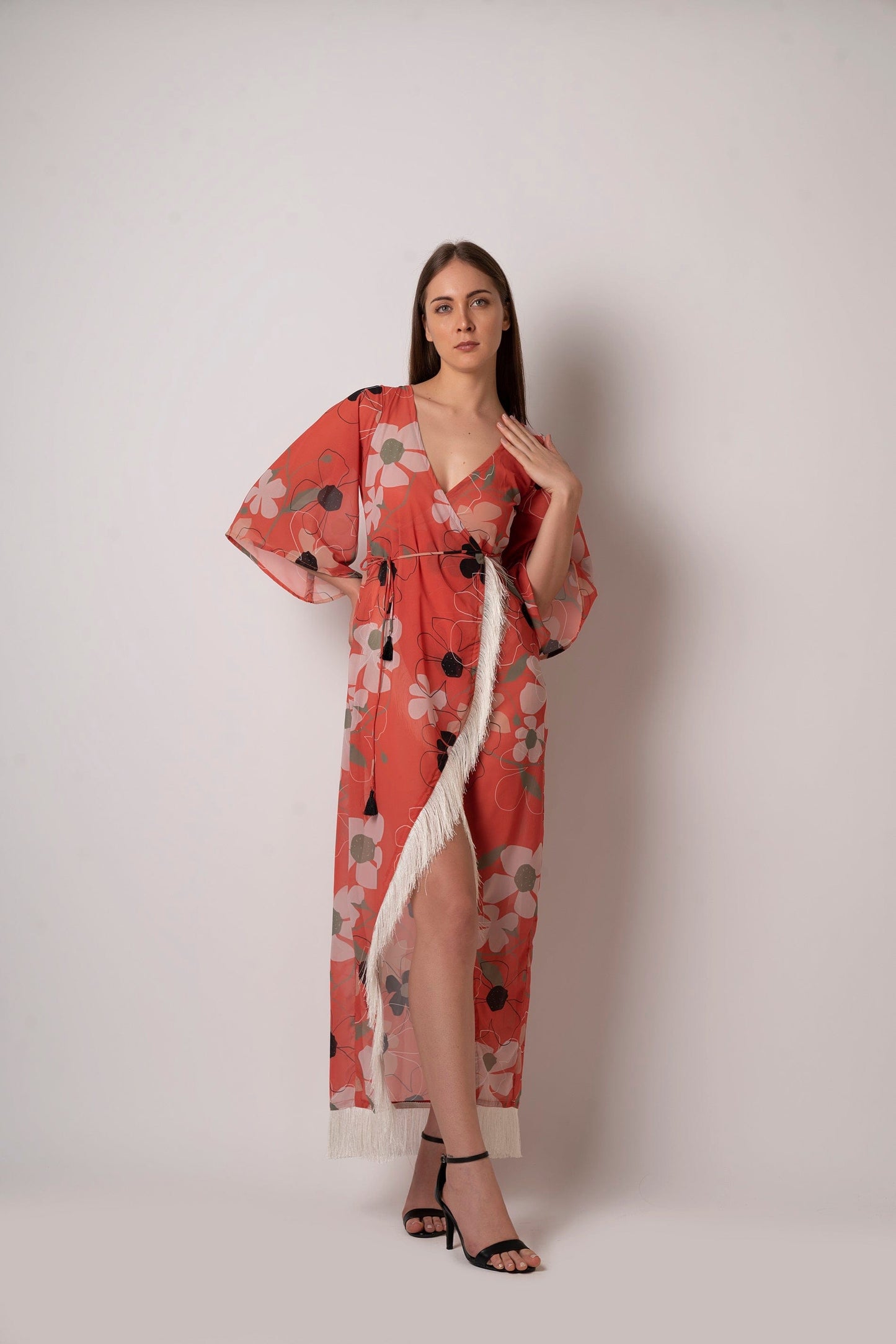 Floral wrap beach kaftan dress made from lightweight georgette fabric. Comes with a waist belt featuring tassel detailing