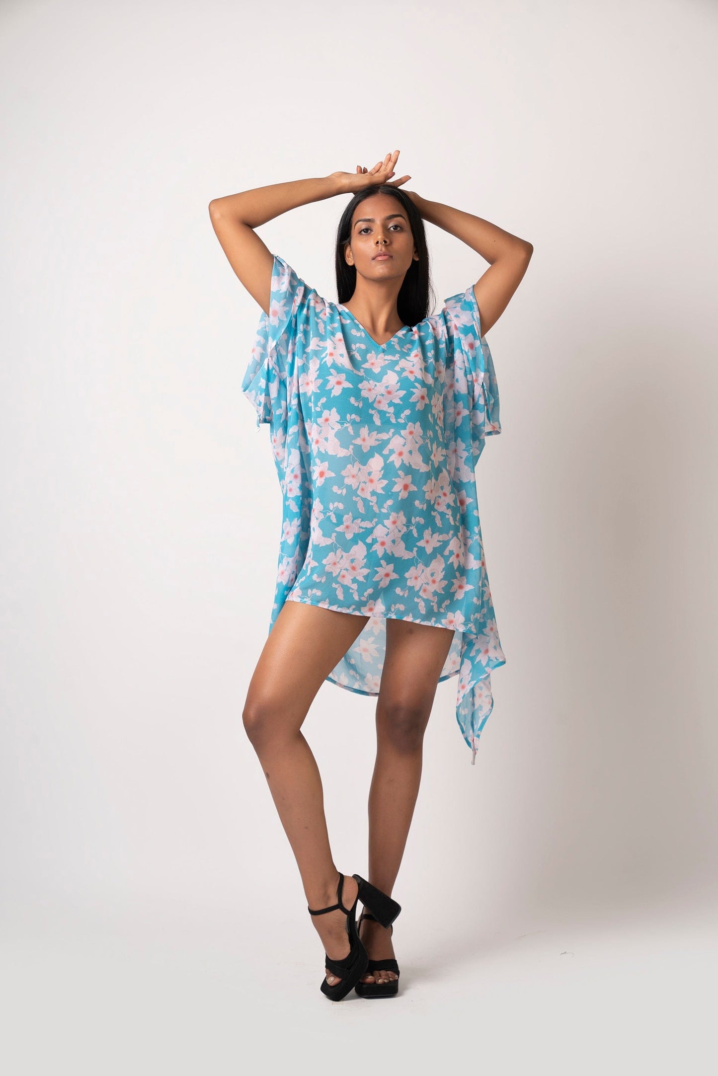 Flowy georgette beach vacation dress featuring distinctive slit sleeves and sea shell accents. Can be worn as a kimono or a mini dress