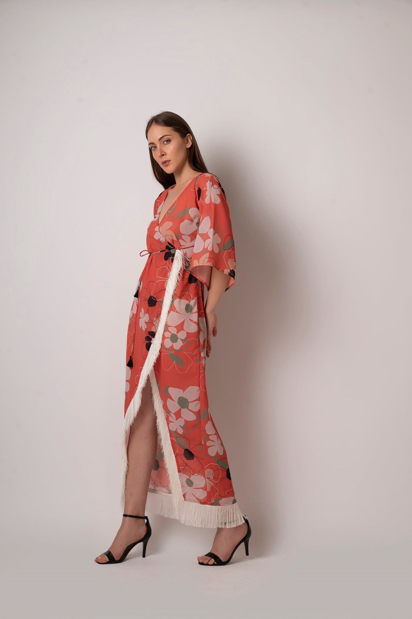 Floral wrap beach kaftan dress made from lightweight georgette fabric. Comes with a waist belt featuring tassel detailing