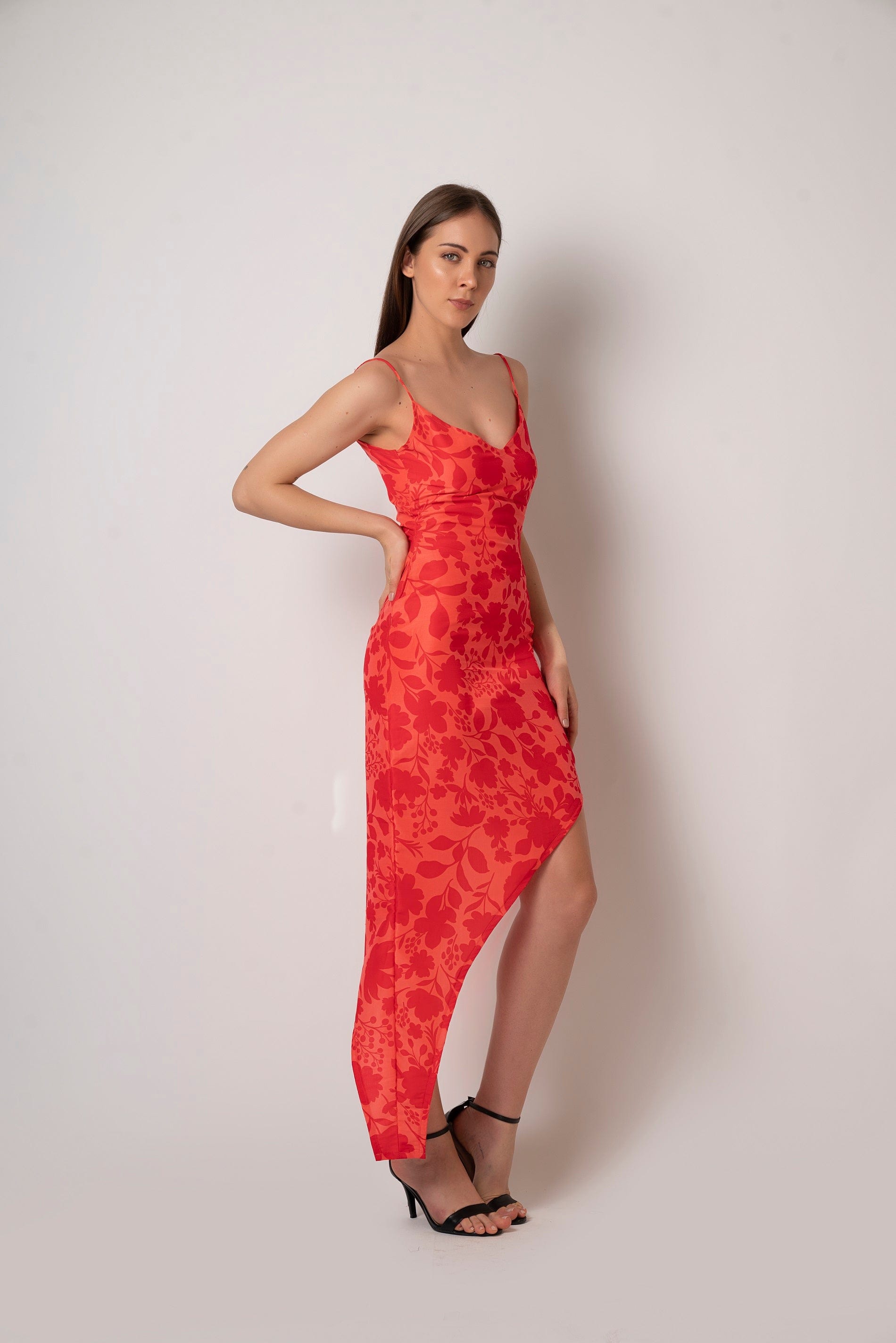 Crafted from breathable muslin fabric, this floral printed dress is light and airy. It features spaghetti straps and a high low cut  making it an ideal summer dress or a beach vacation dress