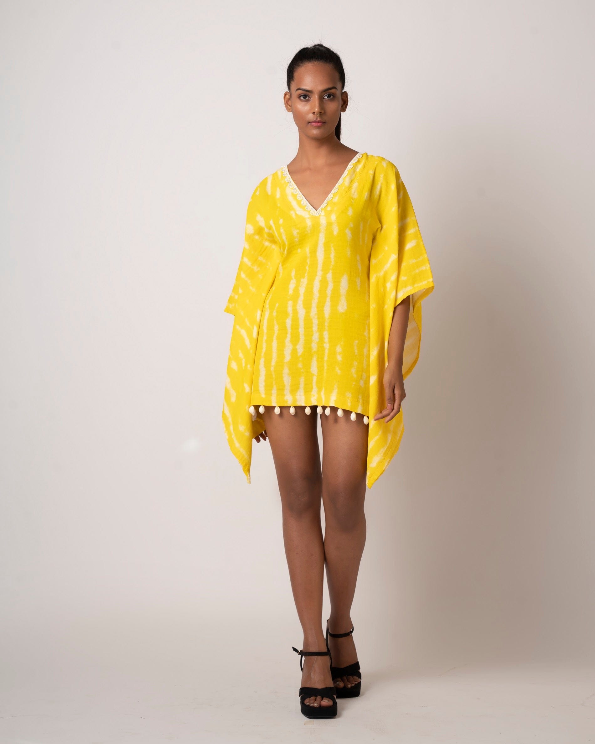 Add a pop of color to your outfit with this vibrant yellow tie-dye short beach dress.  It comes with kimono-style sleeves, yoke collar, and lace detailing and is perfect as a beach vacation dress or for a casual day out.