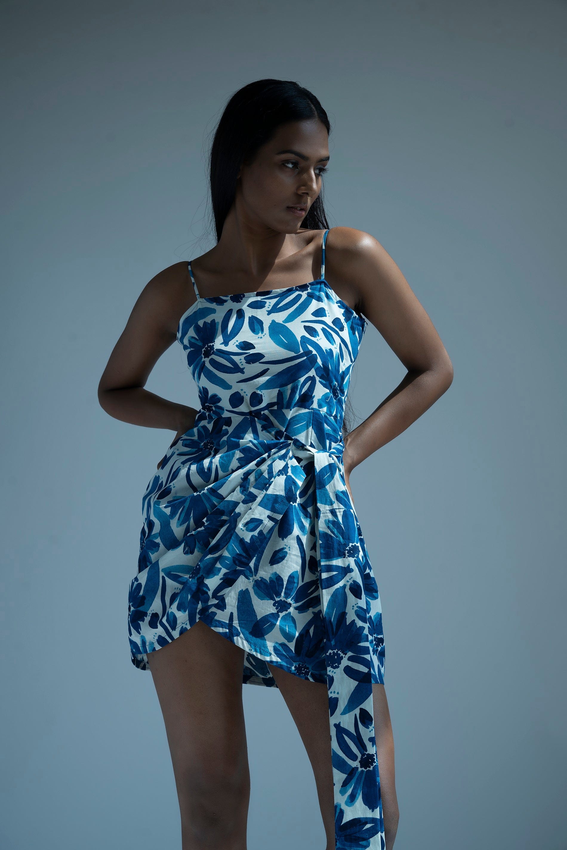 Abstract blue midi vacation dress made of breathable cotton fabric with wrap style tie-up detailing and a flattering midi length. Perfect for summer occasions