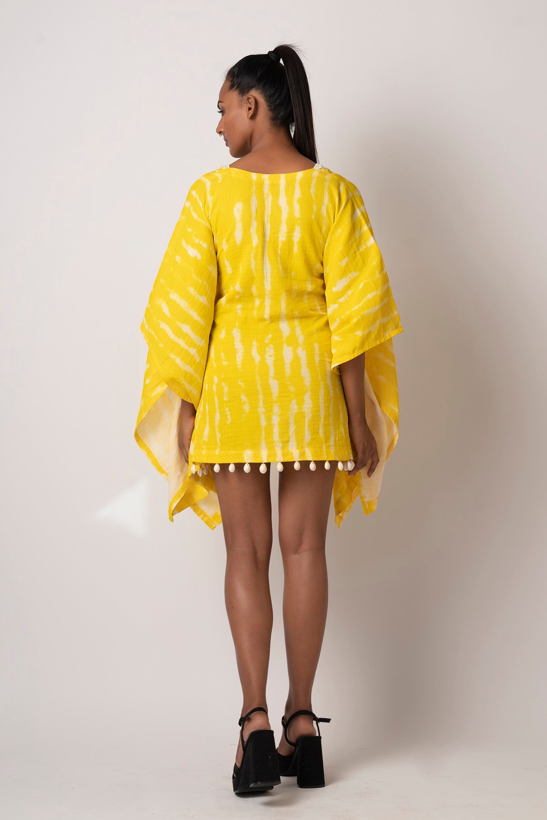 Add a pop of color to your outfit with this vibrant yellow tie-dye short beach dress.  It comes with kimono-style sleeves, yoke collar, and lace detailing and is perfect as a beach vacation dress or for a casual day out.