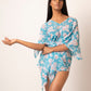Flowy georgette beach vacation dress featuring distinctive slit sleeves and sea shell accents. Can be worn as a kimono or a mini dress
