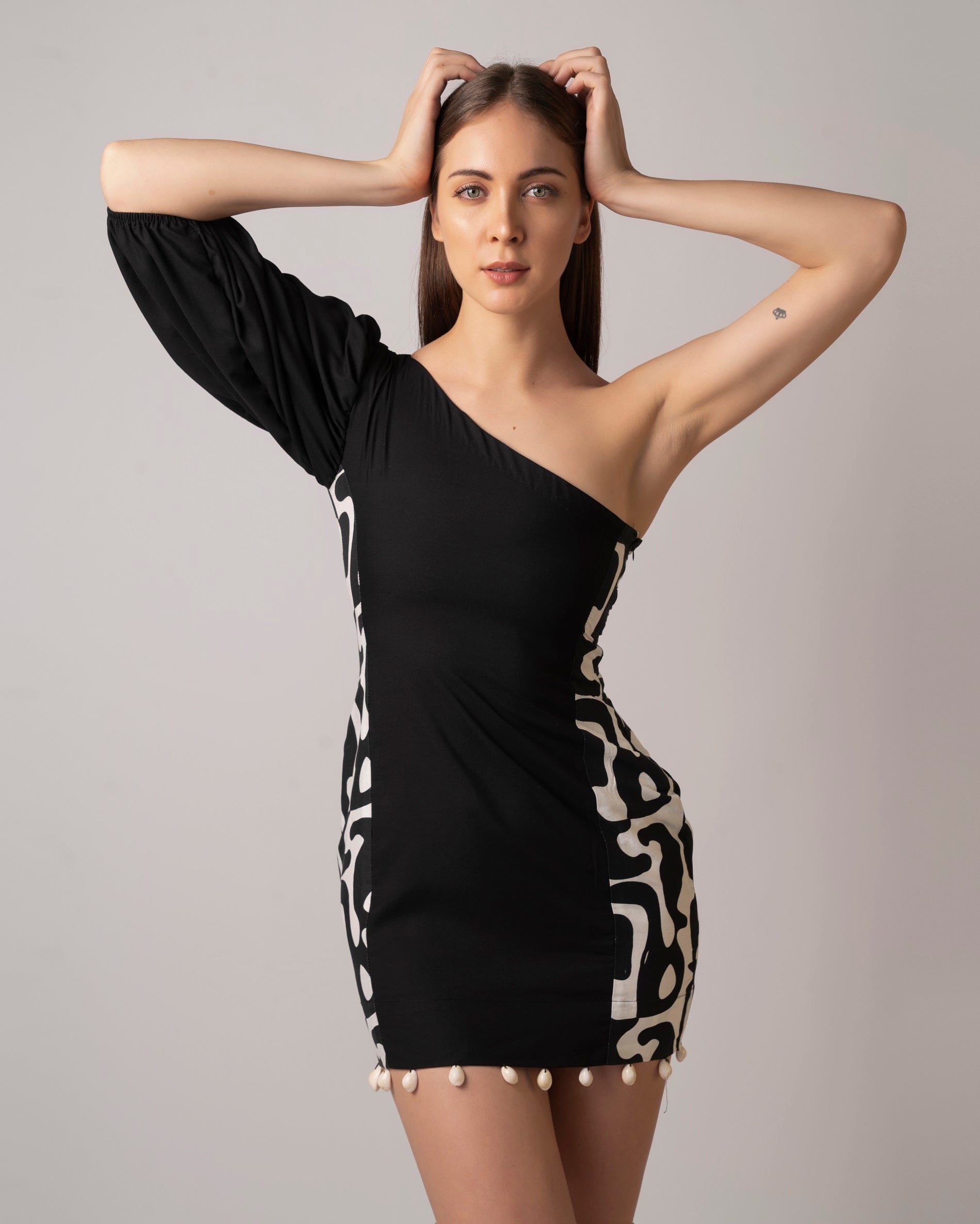 Asymmetrical black cotton dress with puff sleeve detailing, perfect for summer outings and resort wear