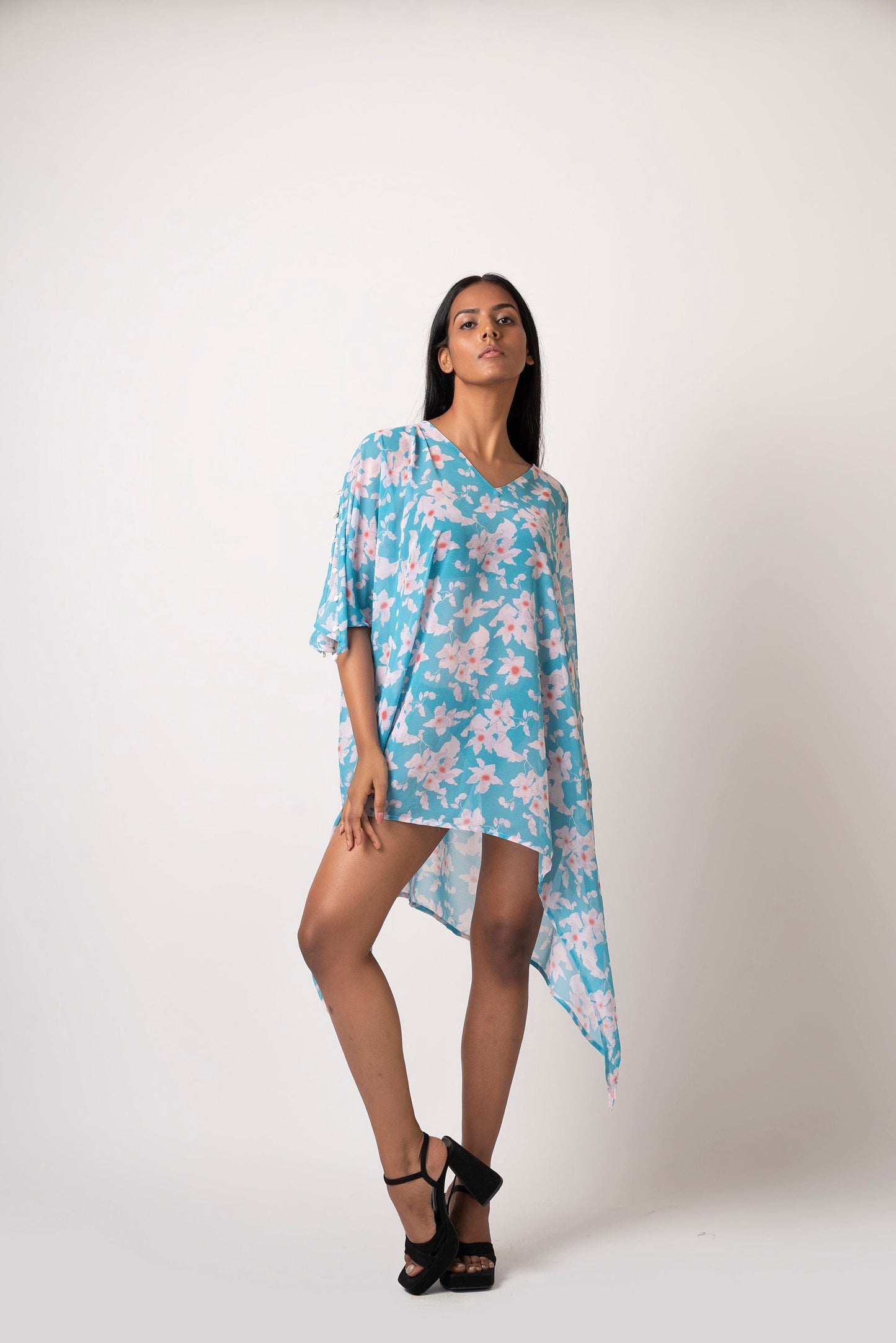 Front pose of blue printed georgette dress, worn loose and flowy with slit sleeves.
