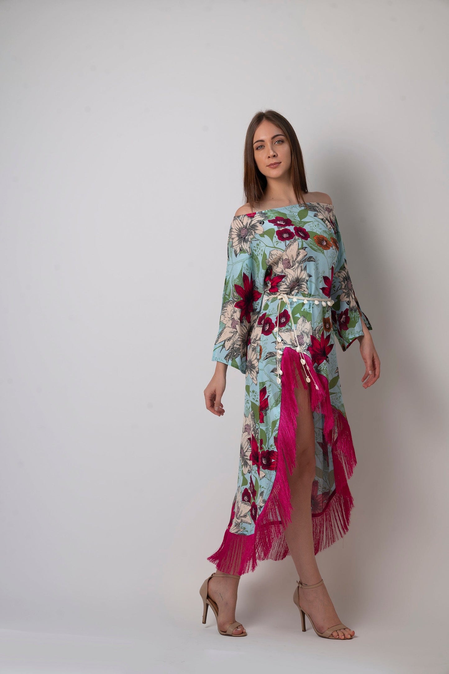 Mid-step dynamic pose with visible fringe detailing and soft flow of fabric, perfect for highlighting movement of the dress.