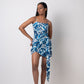 Model in centered standing pose facing forward in abstract cotton midi dress with pleated tie-up waist.
